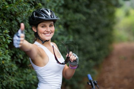 Smiling woman showing thumbs up