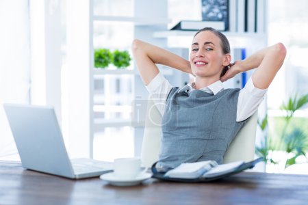 Businesswoman relaxing in a swivel chair