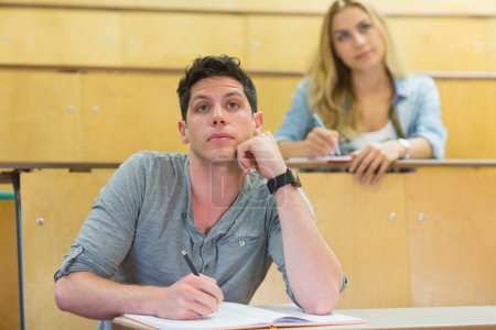 Thoughtful male student during class 