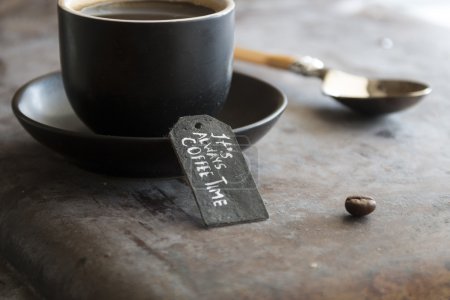 Photo for Spoon and a cup of coffee and tag "it always coffee time" - Royalty Free Image