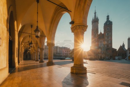 Market square in Krakow at sunrise. Mariacki Cathedral and The Cloth Hall. Poland