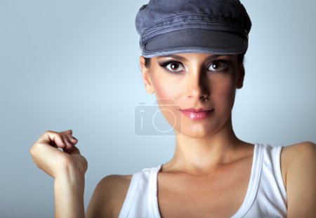 Photo for Portrait of beautiful brown eyes woman with pink lipstick, wearing cap and white t - shirt, studio shoot. - Royalty Free Image