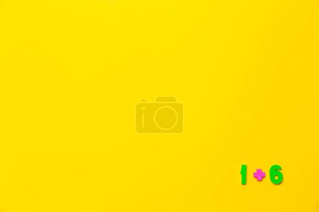 Photo for One plus six equals seven is example on yellow background. Copy space. Math lesson. Primary count teaching. Online course of distance education design mockup. Flat lay. Text place. Back to school. - Royalty Free Image