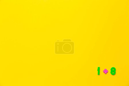 Photo for One plus eight equals nine is example on yellow background. Copy space. Math lesson. Primary count teaching. Online course of distance education design mockup. Flat lay. Text place. Back to school. - Royalty Free Image