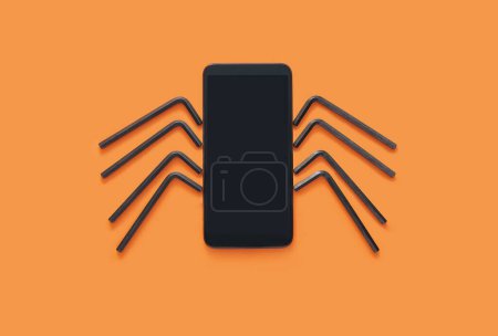 Herramientas de teléfono y llave hexagonal dispuestas en araña. Divertida idea de maqueta de Halloween.