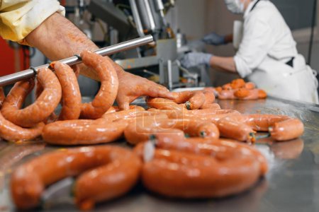 Sausages production at the meat processing factory.