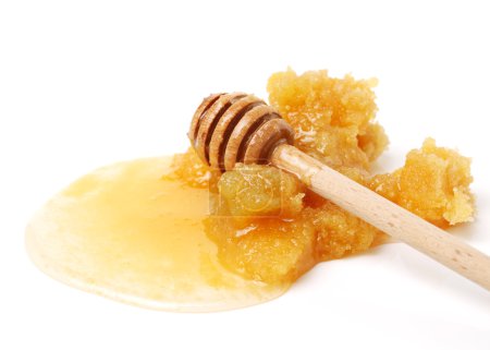 Photo for Naturally crystallized rape honey with honey stick isolated on white wooden - Royalty Free Image