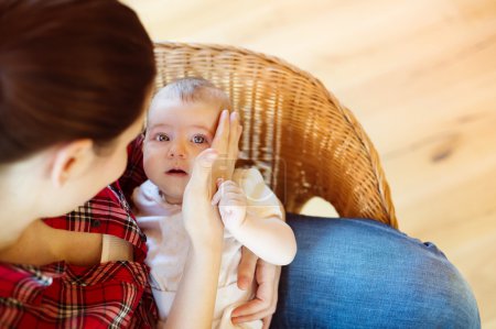 Téléchargez les photos : Pleurer petit bébé dans les bras de sa mère dans un salon
. - en image libre de droit