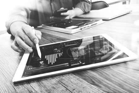 Photo for Businessman hand touching digital tablet.Photo finance manager working new Investment project office.Using new technology device.Graphic icons.Strategy business stock exchanges interface layer effect, black whit - Royalty Free Image