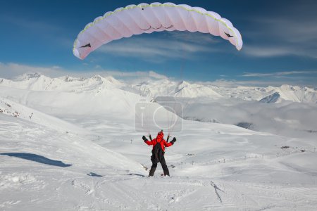 Paraglider in winter Caucasus mountains in Georgia