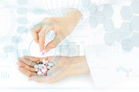 Dedos femeninos recogiendo una cápsula de un puñado de medicamentos en un fondo científico abstracto. Imagen conceptual para la industria farmacéutica y la investigación química.