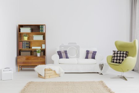 Photo for Very bright and clear living room with modernist bookcase and a comfy sofa - Royalty Free Image