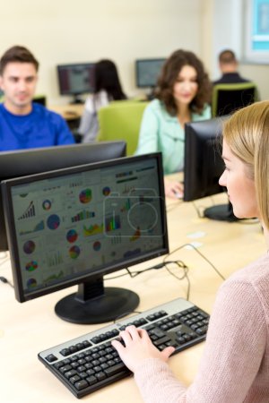 Photo for Young woman is sitting while solving computer tasks in courses - Royalty Free Image