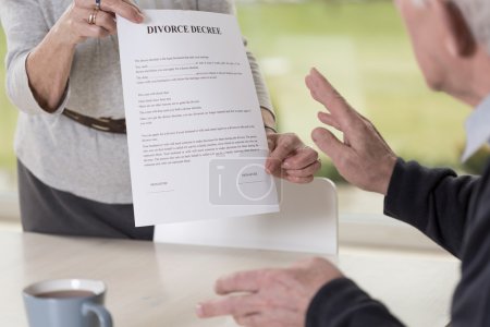 Female hands holding divorce paper