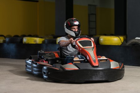 Photo for Young Man Is Driving Go-Kart Car With Speed In A Playground Racing Track - Go Kart Is A Popular Leisure Motor Sports - Royalty Free Image