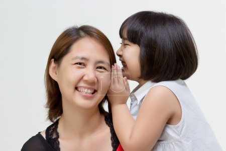 Photo for Portrait of Asian daughter whispering to her mother on isolated - Royalty Free Image