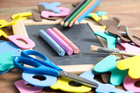 Photo for Slate with some school tools - Royalty Free Image