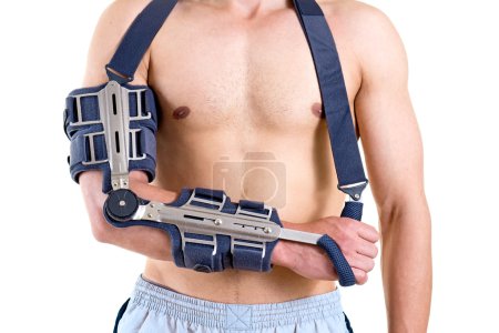 Photo for Close Up of Shirtless Athletic Man with Arm Secured in Modern Sling with Articulated Elbow in Studio with White Background. - Royalty Free Image