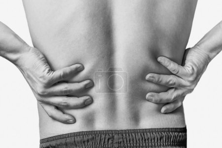 Photo for Acute pain in a male lower back. Monochrome image, isolated on a white background - Royalty Free Image