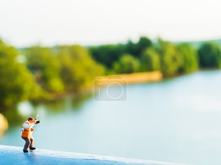 Photo for Lovely plastic toy standing outdoor to take photos with riverside background - Royalty Free Image