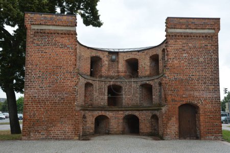 A historic Friedland Gate, an old brick building in Neubrandenburg, Germany on a gloomy day