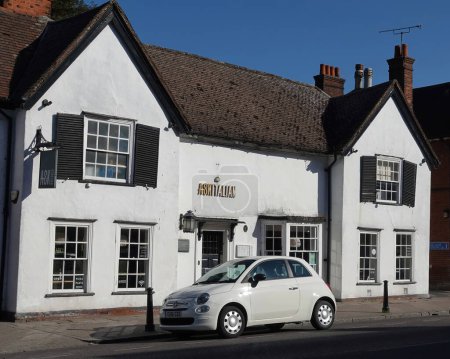 BILLERICAY, UNITED KINGDOM - Jun 13, 2021: A white Fiat 500 car parked near Ask Italian restaurant in Billericay High Street