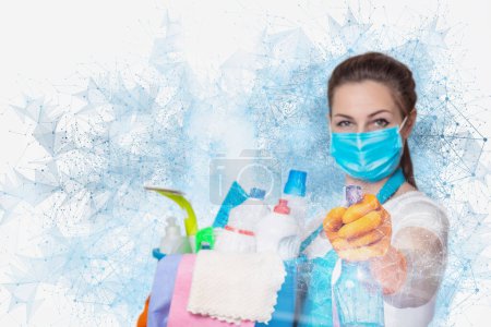 El concepto de servicios de limpieza durante una pandemia. La señora de la limpieza con un spray en las manos en el fondo de una conexión de red.