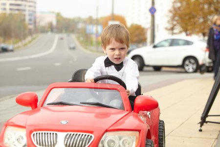 little boy driving car