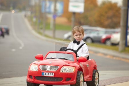 little boy driving car