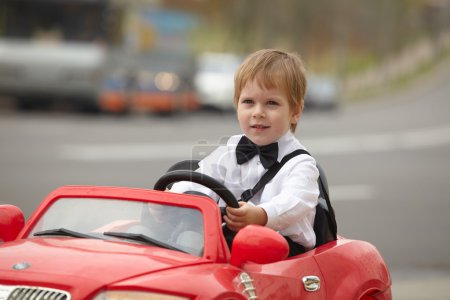 little boy driving car