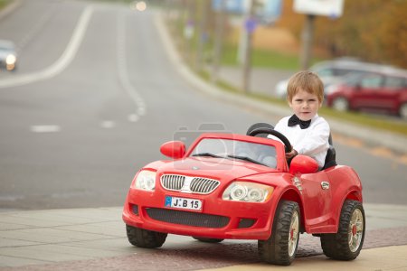 little boy driving car