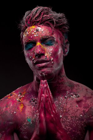 Photo for A creepy portrait of a halloween man with bloody body art and face art praying - Royalty Free Image