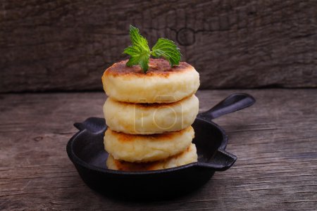 Photo for Ricotta pancakes, Syrniki (Cottage cheese pancakes, Fritters of cottage cheese) traditional Ukrainian and Russian cuisine. - Royalty Free Image