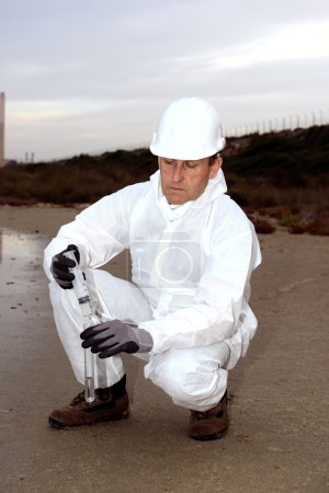 Photo for Technical environment carries out checks and analysis. Hands control polluted water. Gray sky at dusk. - Royalty Free Image