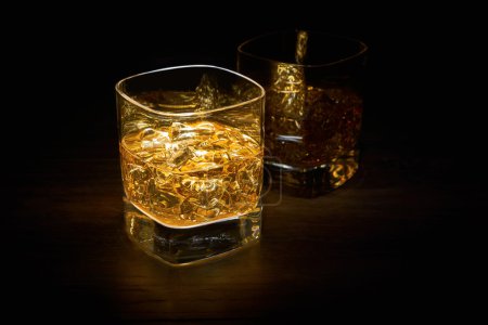 Photo for Two Single Malt Whiskey in glasses on a wooden table top. - Royalty Free Image