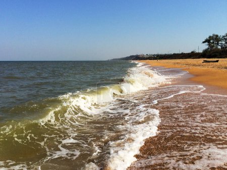Photo for Big waves roll over the sandy seaside - Royalty Free Image
