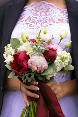 Photo for A bouquet of peony flowers in the hands of the bride - Royalty Free Image