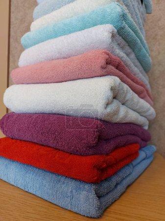 Photo for Multi-colored cotton terry towels are stacked. Home textile background - Royalty Free Image