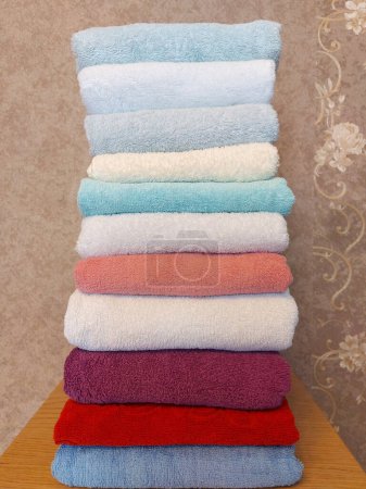 Photo for Multi-colored cotton terry towels are stacked. Home textile background - Royalty Free Image