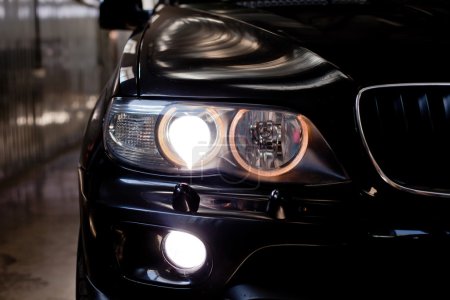 Photo for Headlights of nice black car. Garage theme - Royalty Free Image