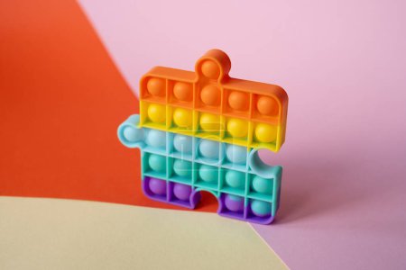 Photo for New popular silicone colorful anti-stress popit toy for baby on the background with geometric shapes. simple dimple. Pop it toy - Royalty Free Image