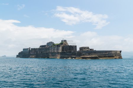 Photo for Hashima Island, commonly called Gunkanjima (meaning "Battleship Island"), is former coal mining island. It's one of the oldest coal mine in Japan.  It is listed on Tentative list of World Heritage Sites as a industrial heritage. - Royalty Free Image