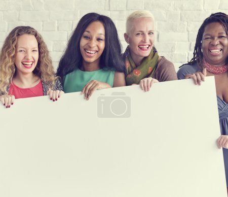 Foto de Grupo de mujeres de diversidad sostiene cartel en blanco Concepto - Imagen libre de derechos