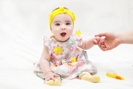 Photo for Adorable little baby girl laughing, creeping and playing in the studio, isolated on white background - Royalty Free Image