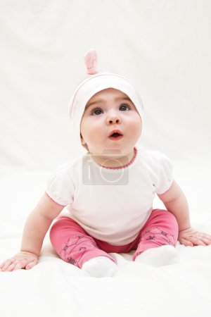 Photo for Adorable little baby girl sitting on the floor, studio shot, isolated on white background, lovely baby portrait - Royalty Free Image