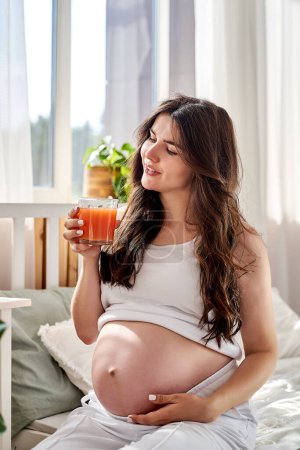 Photo for A beautiful pregnant woman eats right and drinks fresh natural juice. - Royalty Free Image