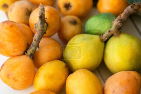 Photo for Fresh loquats on white wooden background - Royalty Free Image