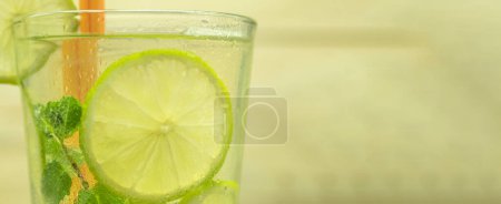 Photo for A glass of cold lemonade and ice. Homemade lemonade with lemons and limes. Background with place for text - Royalty Free Image