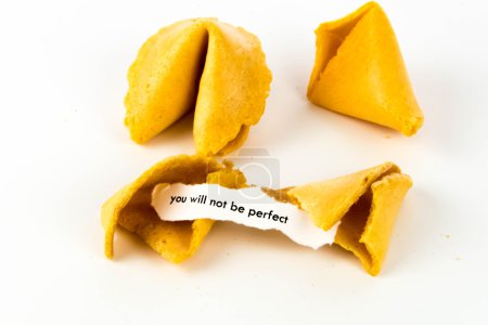 Photo for Open fortune cookie with strip of white paper - YOU WILL NOT BE PERFECT - Royalty Free Image