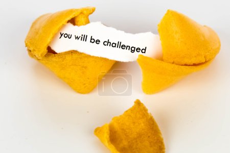 Photo for Open fortune cookie with strip of white paper - YOU WILL BE CHALLENGED - Royalty Free Image